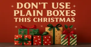 Colourful Christmas gift boxes with red and green ribbons and festive wrapping, placed under a message reading ‘Don’t Use Plain Boxes This Christmas’ on a red holiday background.